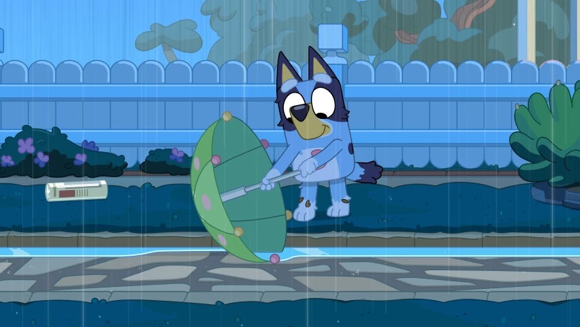 “Bluey” draws scenarios from intimately relatable experiences. Here Bluey tries to use her umbrella to dam the stream of rainwater (Ludo Studio)