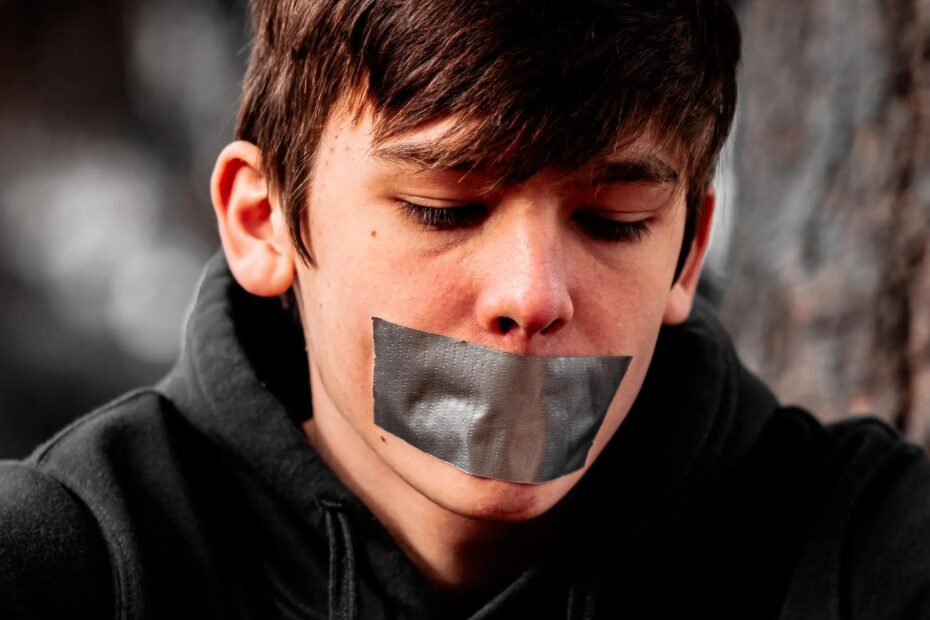 Young boy with duct tape over his mouth