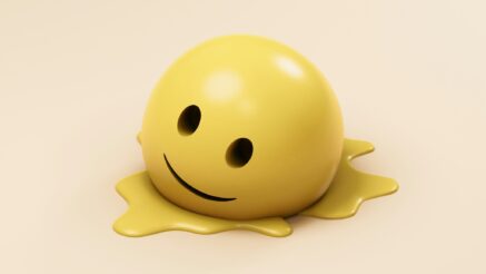 A melting smiley face on a creamy background.